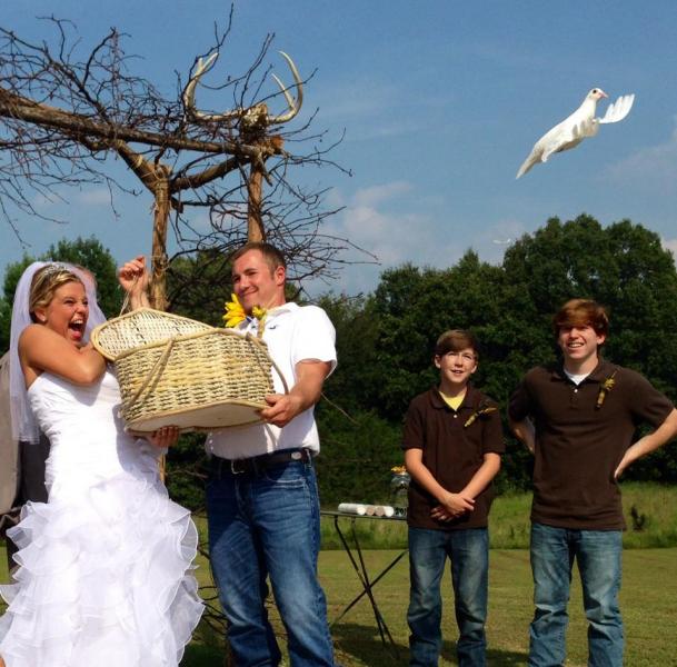 bride and groom releasing dove at wedding